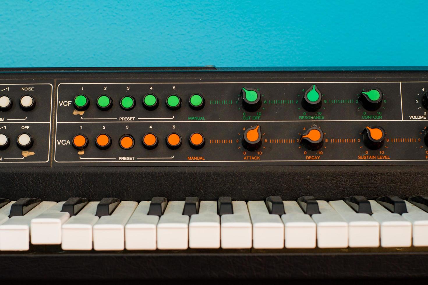 Old synthesizer with colorfull switches on blue background photo