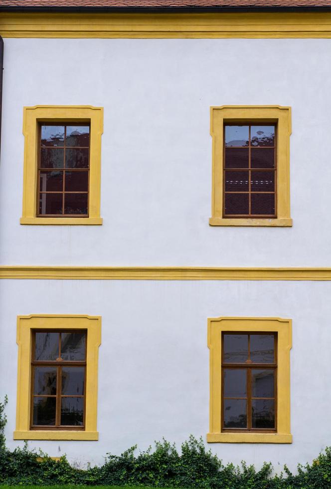 facade of an old german house with wooden windows and white walls photo