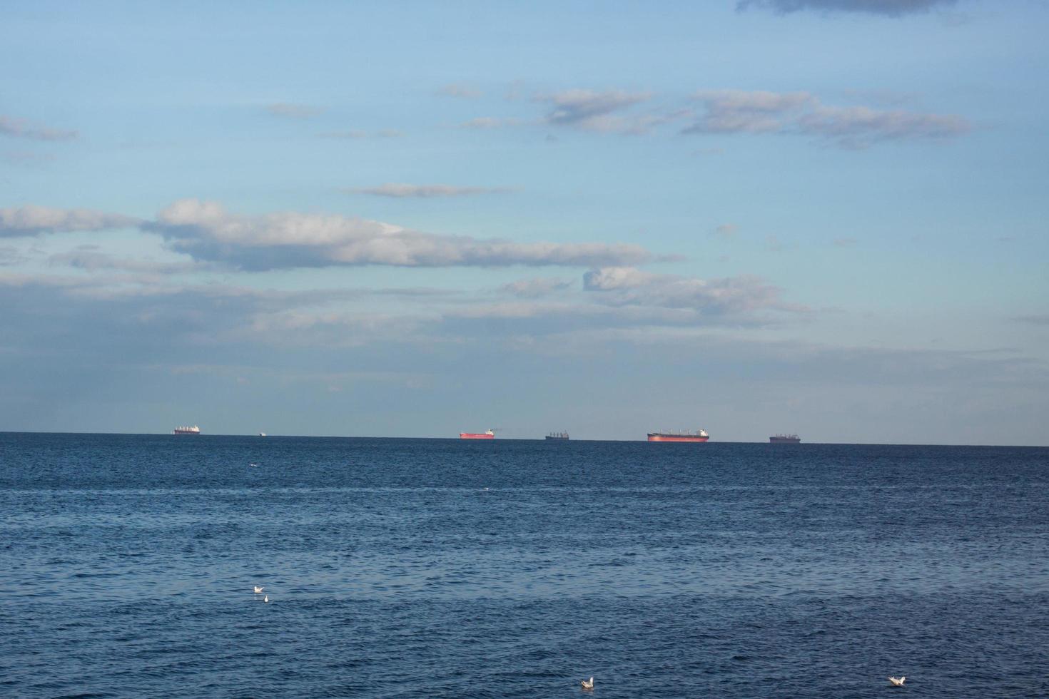 Landscape with cargo ships on horizon photo