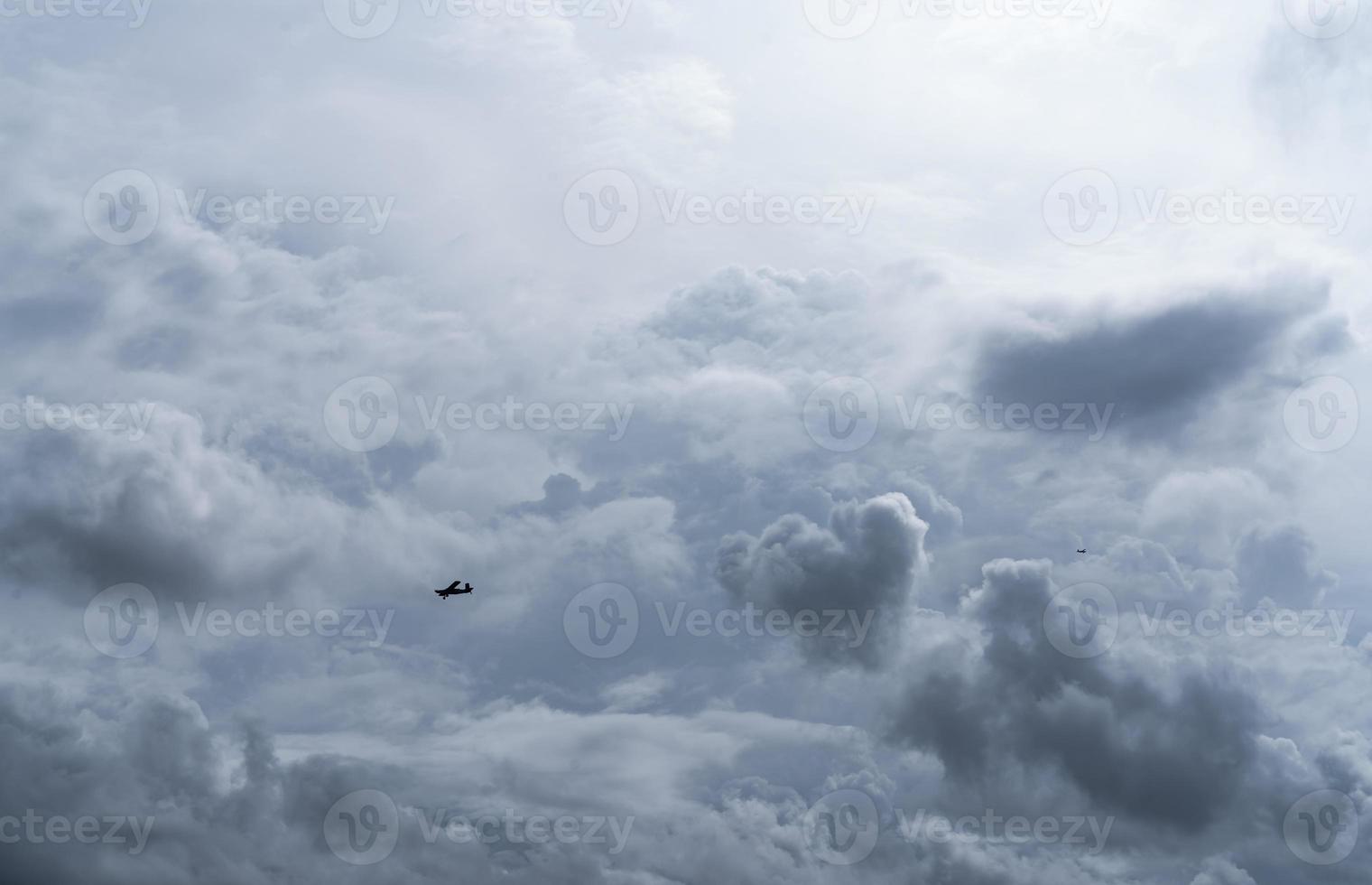 Small plane in cloudy sky for rainmaking. White fluffy clouds with