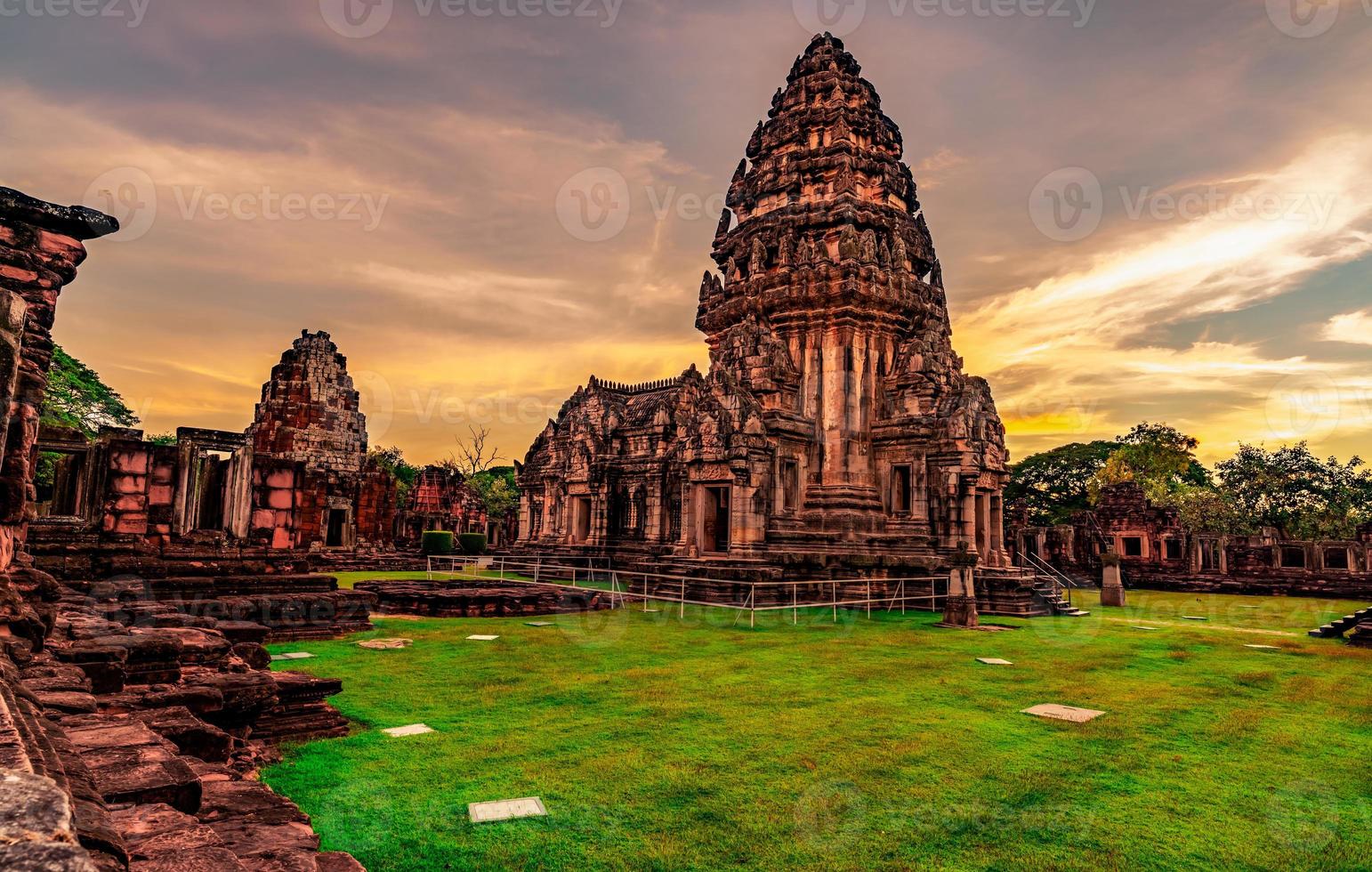 Landscape of Phimai Historical Park with sunset sky. Landmark of Nakhon Ratchasima, Thailand. Travel destinations. Historic site is ancient. Ancient building. Khmer temple classical architecture. photo