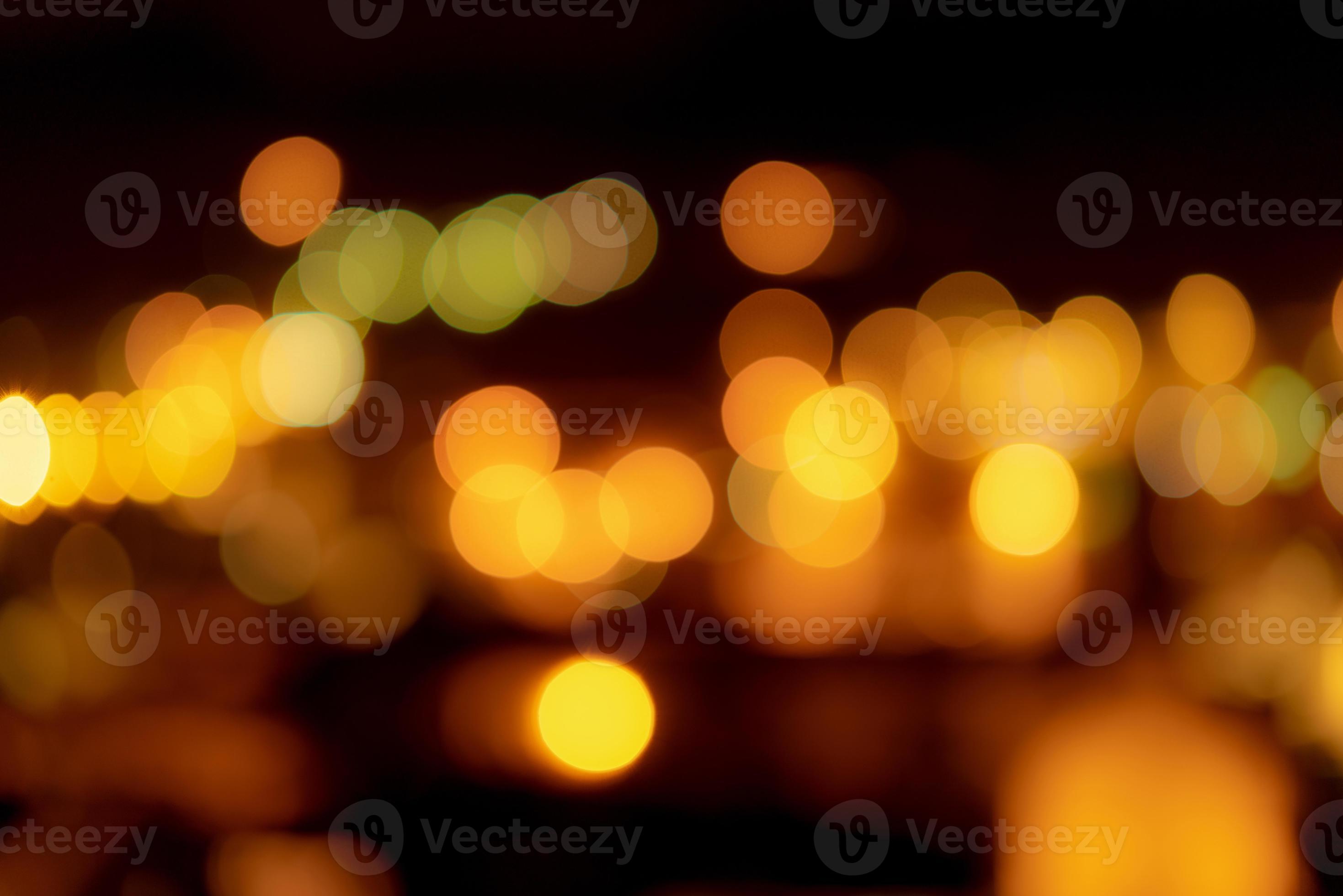 Blurred orange bokeh background. Blur abstract background of urban light.  Warm light with beautiful pattern of round bokeh. Orange light in the  night. Street lamp blurred lights in the city at night.