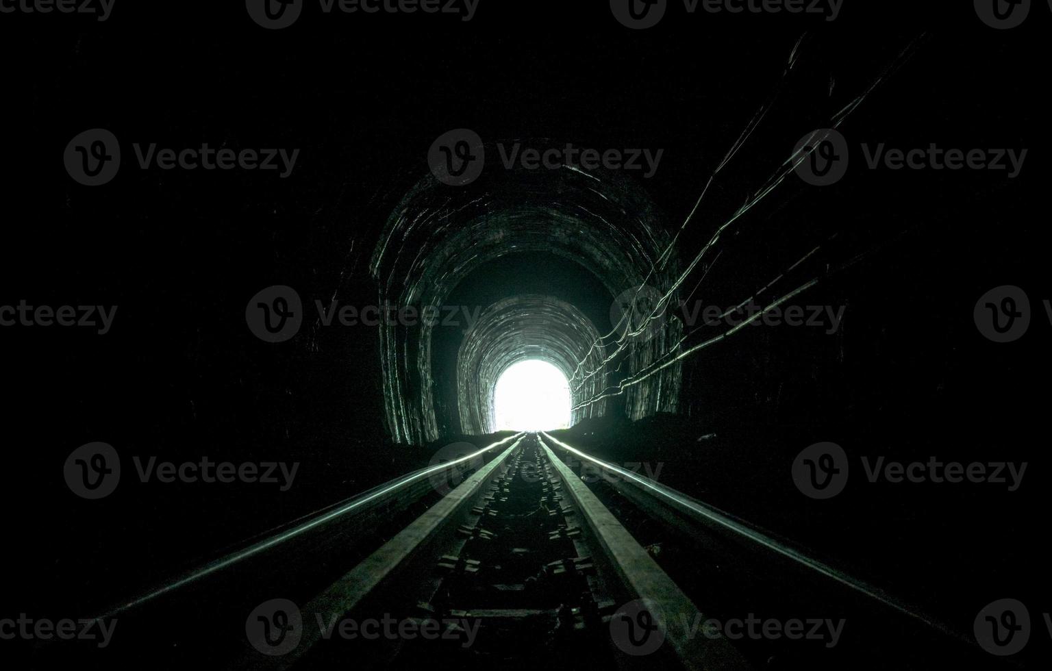 Train tunnel. Old railway in cave. Hope of life in the end of the way. Railroad of locomotive train in Thailand. Old architecture. Railway tunnel built in 1914. Travel and hope at the destination. photo