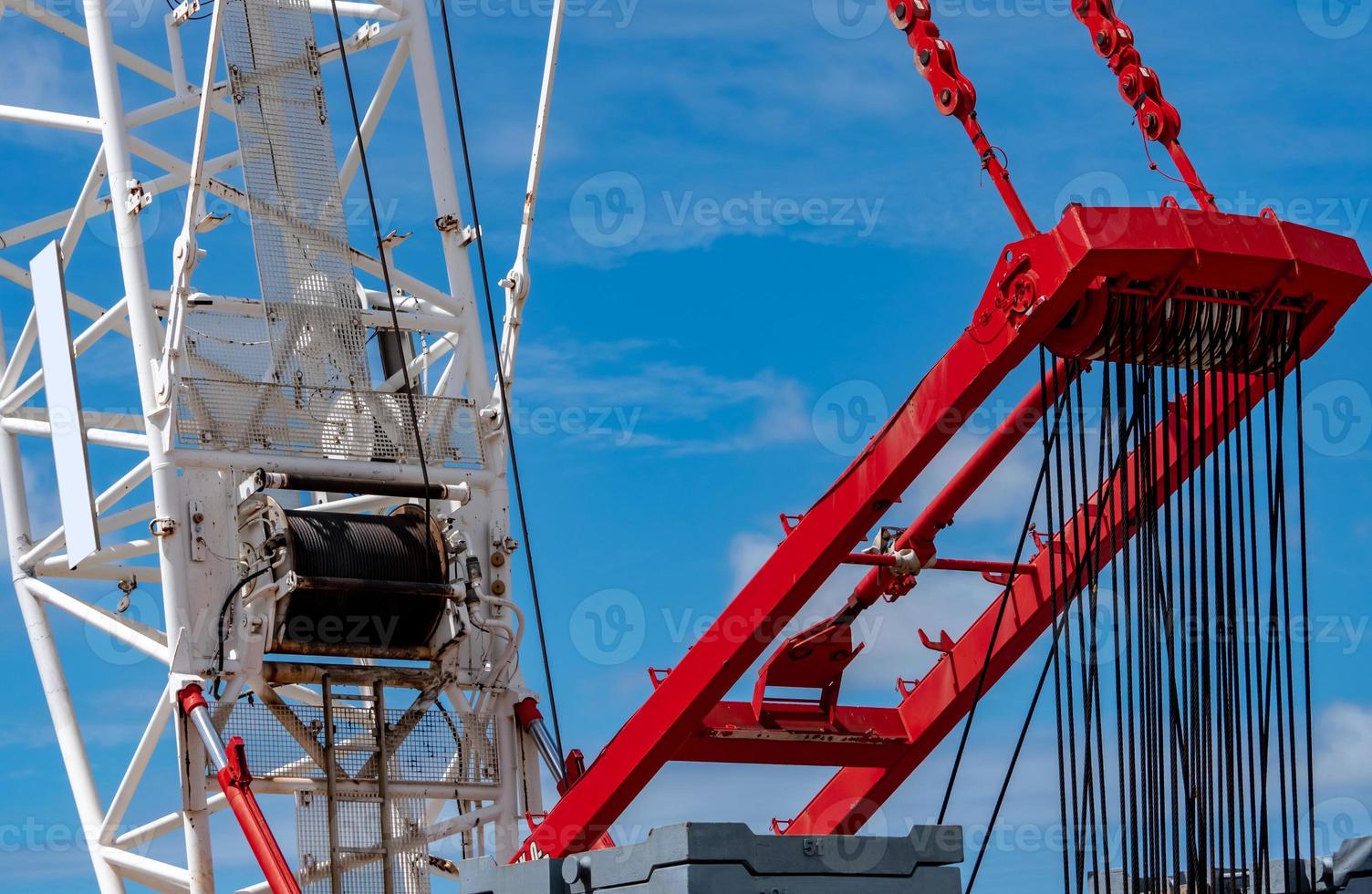 Closeup crawler crane with wire rope sling on crane reel against blue