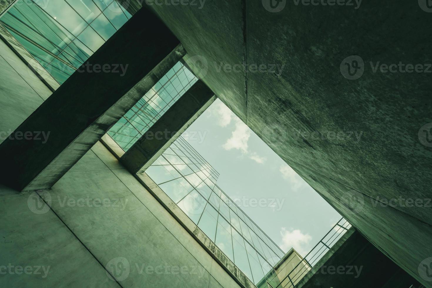 Bottom view modern glass office building. Exterior office glass building architecture. Company glass window. Skyscraper corporate building. Financial business center tower. Perspective of building. photo