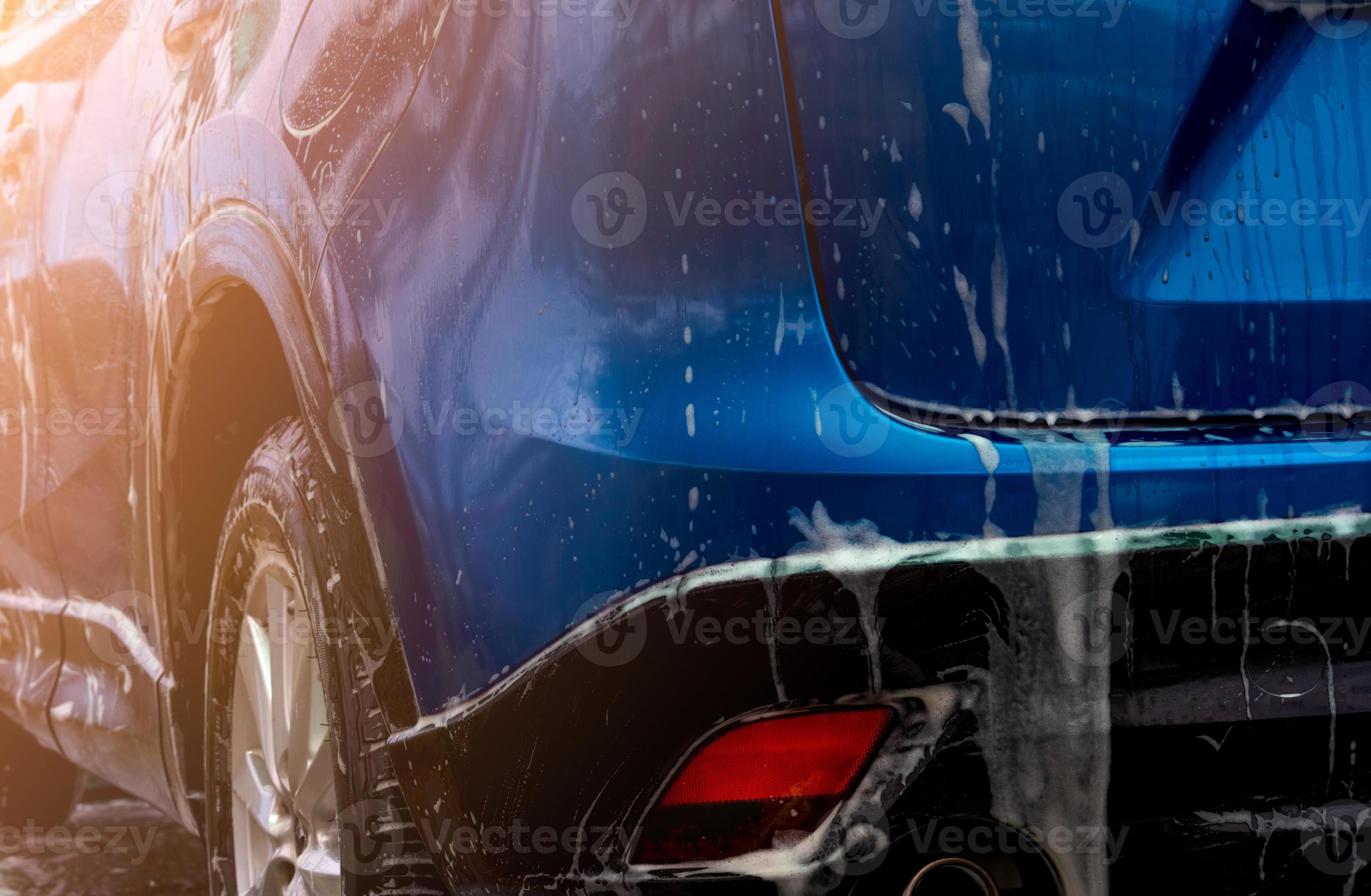 Blue car wash with white soap foam. Auto care business. Car cleaning