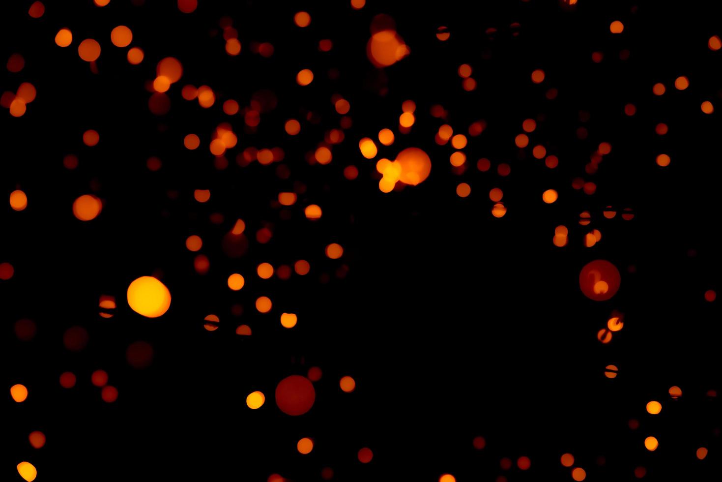 Christmas and happy new year decoration light. Red and orange color bokeh background with beautiful pattern. Defocused Xmas light in the night of party. Christmas holiday bokeh background. photo