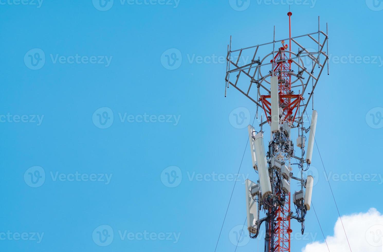 Telecommunication tower with blue sky and white cloud background. The antenna on blue sky. Radio and satellite pole. Communication technology. Telecommunication industry. Mobile or telecom 4g network. photo