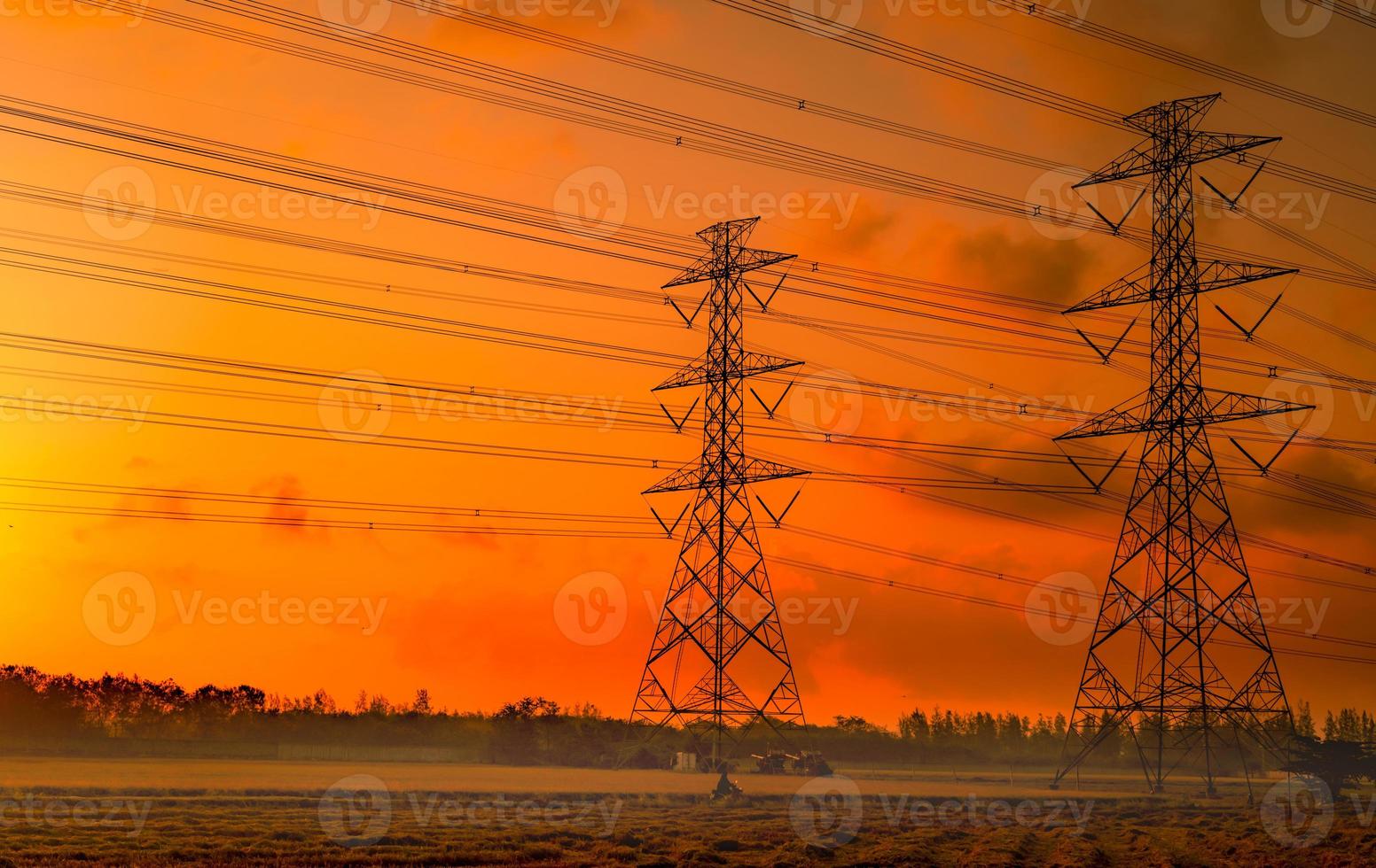 High voltage electric pylon and electrical wire with sunset sky. Electricity poles. Power and energy concept. High voltage grid tower with wire cable. Beautiful red-orange sunset sky. Infrastructure. photo