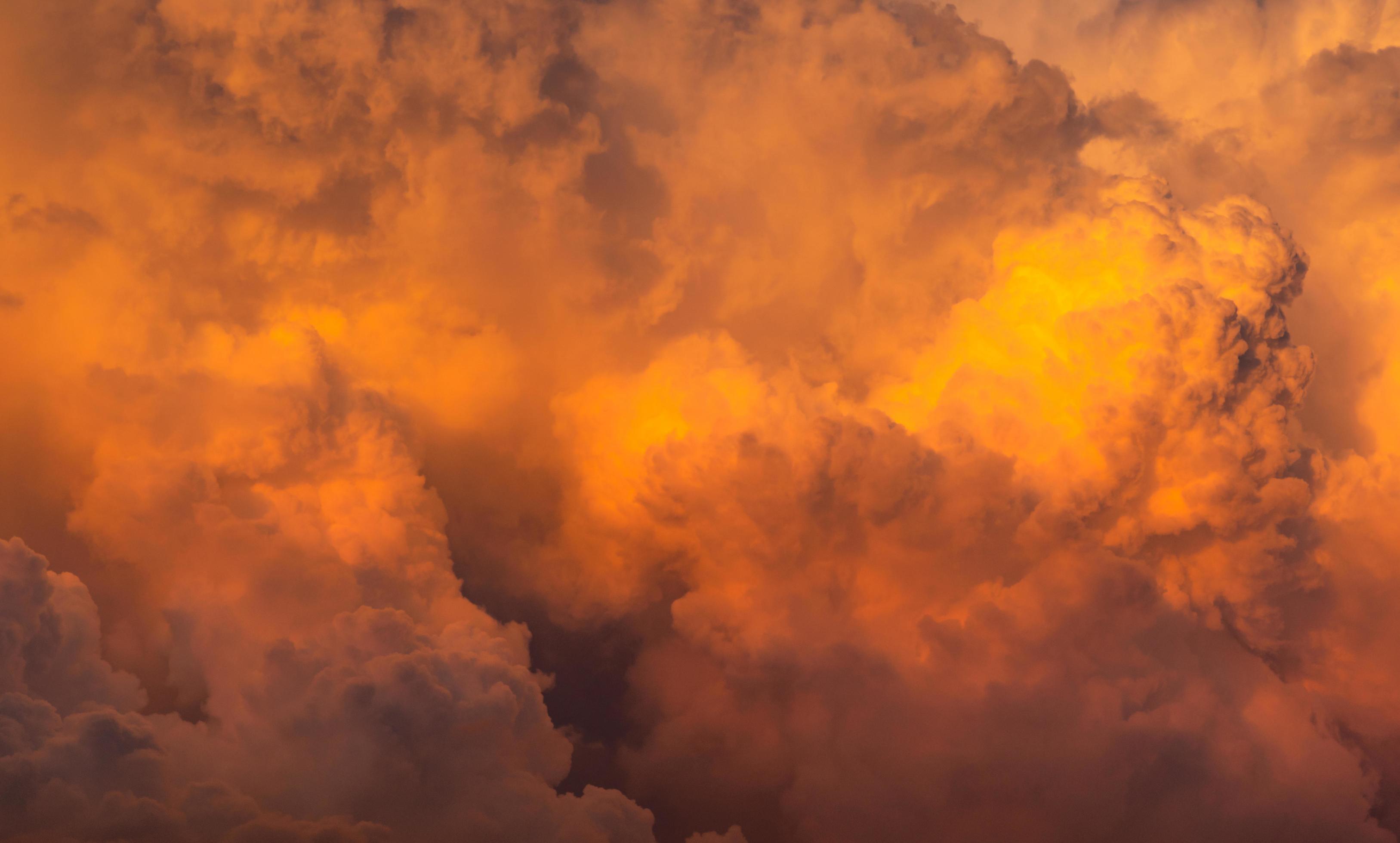 Dramatic orange sky and clouds abstract background. Top view of orange