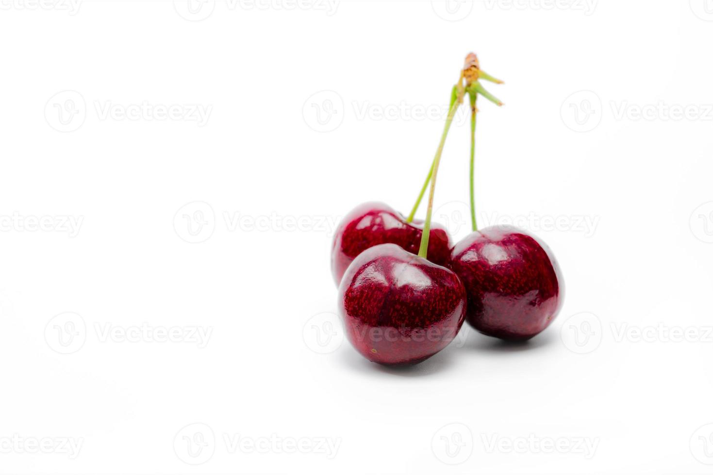Red cherry with stalk isolated on white background. Ripe red sweet cherry. Sweet and juicy organic cherry. Fresh fruit for summer dessert. Antioxidant food. Healthy snack. photo