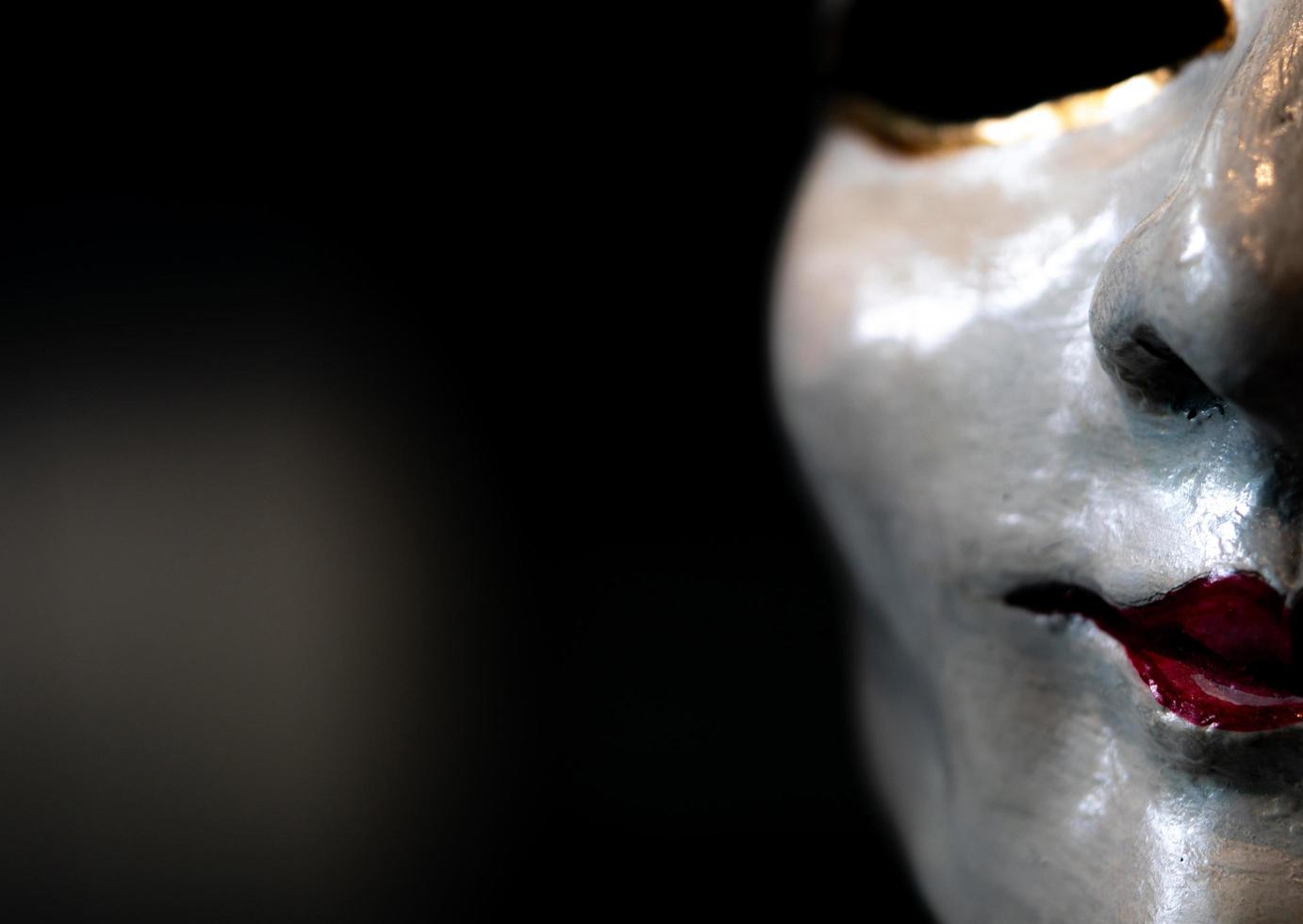 Statue face of woman made of plaster. Statue face of woman on dark background. Sculpture art. Statue face of woman looking for something. Red lips. Smile woman. photo