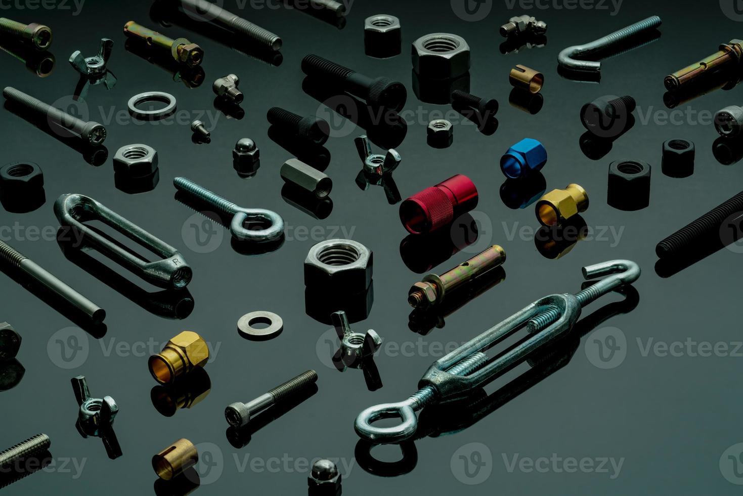 Metal bolts, nuts, and washers. Fasteners equipment. Hardware tools. Different types of nuts, bolts, and screws on table in workshop. Mechanic tools. Threaded fastener use in automotive engineering. photo