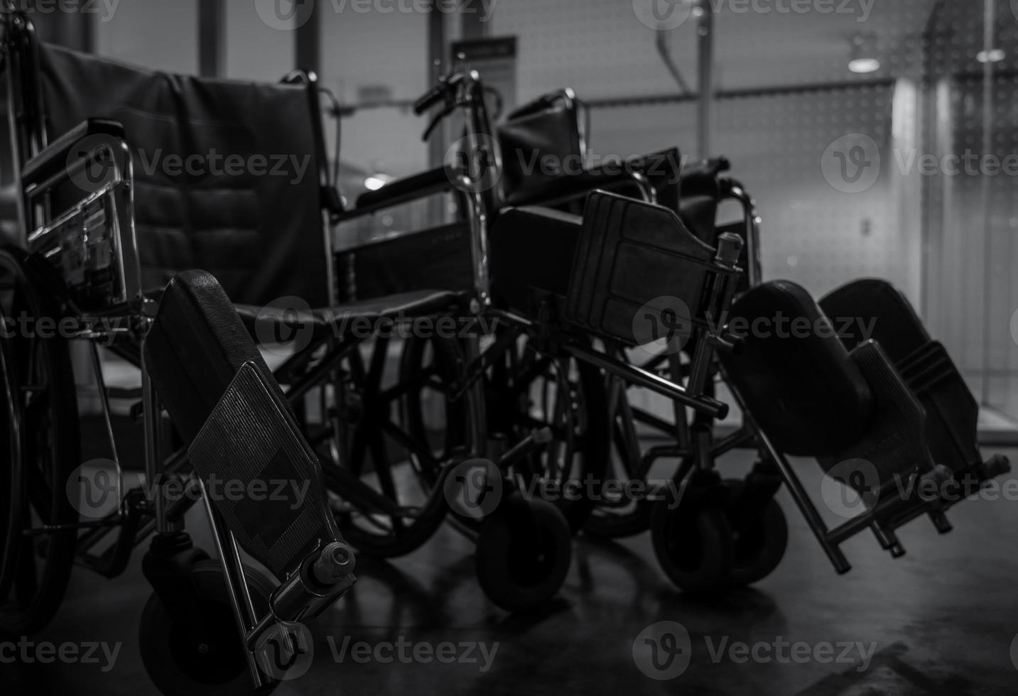 Empty wheelchair in hospital at night for service patient and disabled people. Medical equipment in hospital for assistance handicapped old people. Chair with wheels for patient care in nursing home. photo