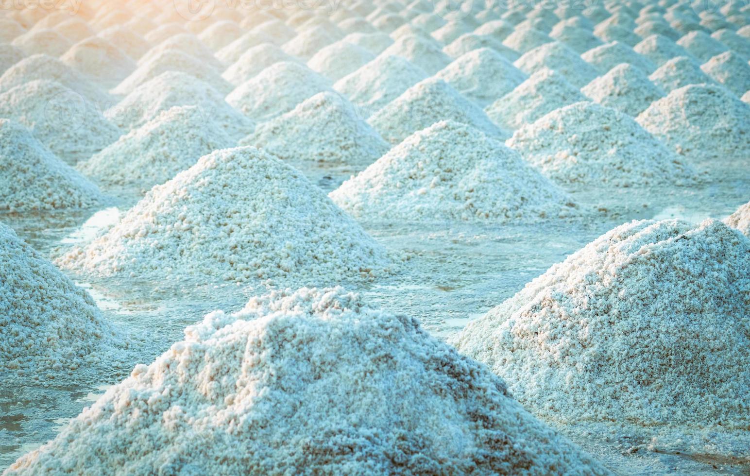 Sea salt farm in Thailand. Organic sea salt. Evaporation and crystallization of sea water. Raw material of salt industrial. Sodium Chloride. Solar evaporation system. Iodine source. Closeup salt pile photo