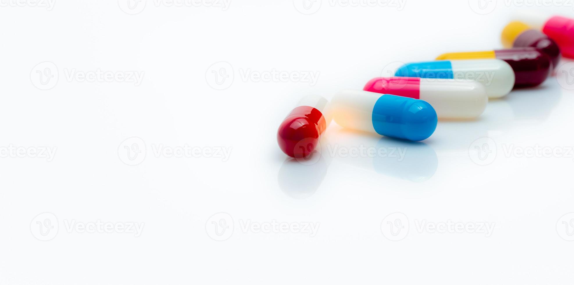 Selective focus on antibiotic capsule pills on white background. Pharmacy horizontal web banner. Prescription drugs. Antibiotic drug resistance. Capsule pill industry. Antibiotic drug selection. photo