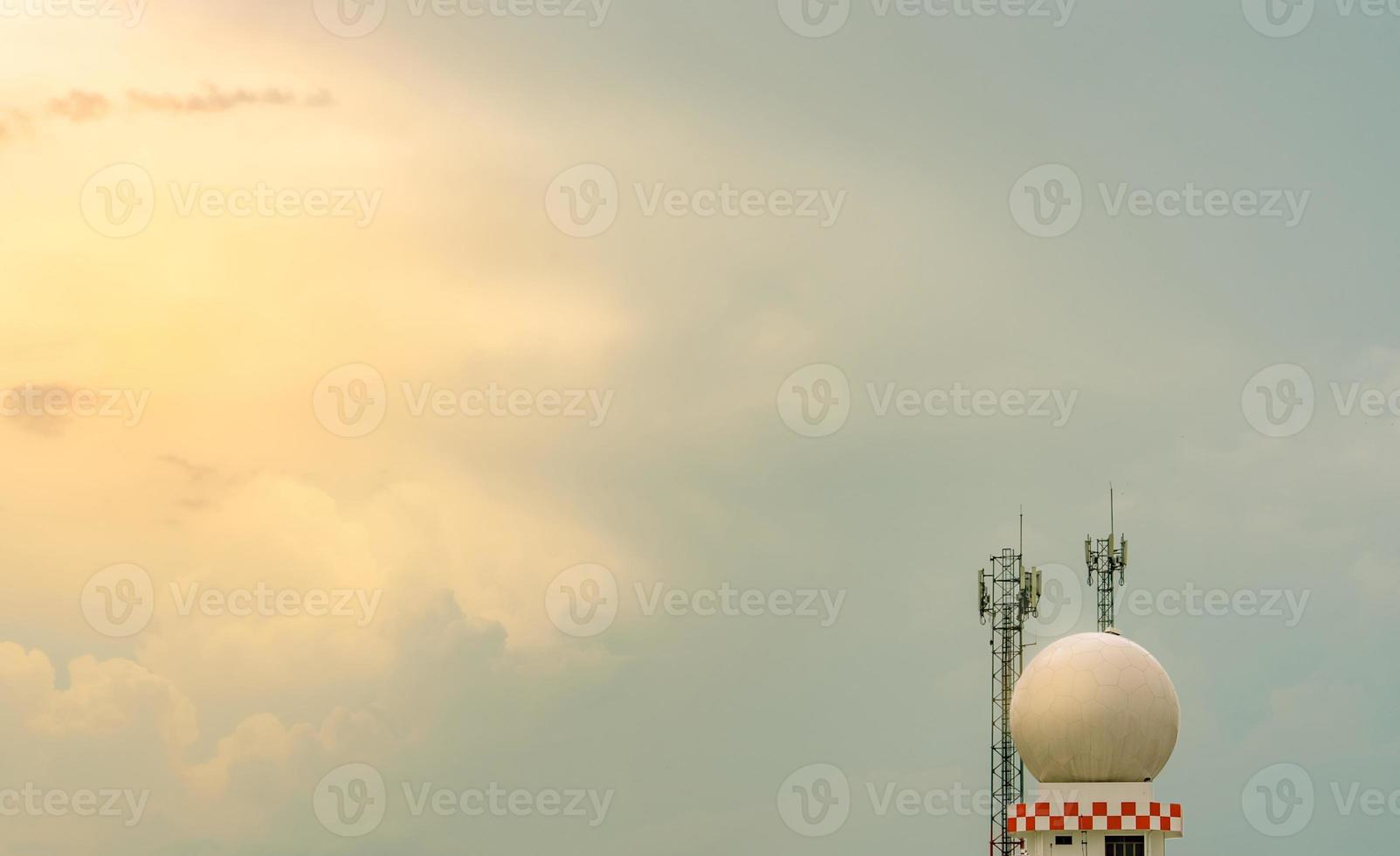Weather observations radar dome station and telecommunication tower against blue sky and clouds. Aeronautical meteorological observations station tower use for safety aircraft in aviation business. photo