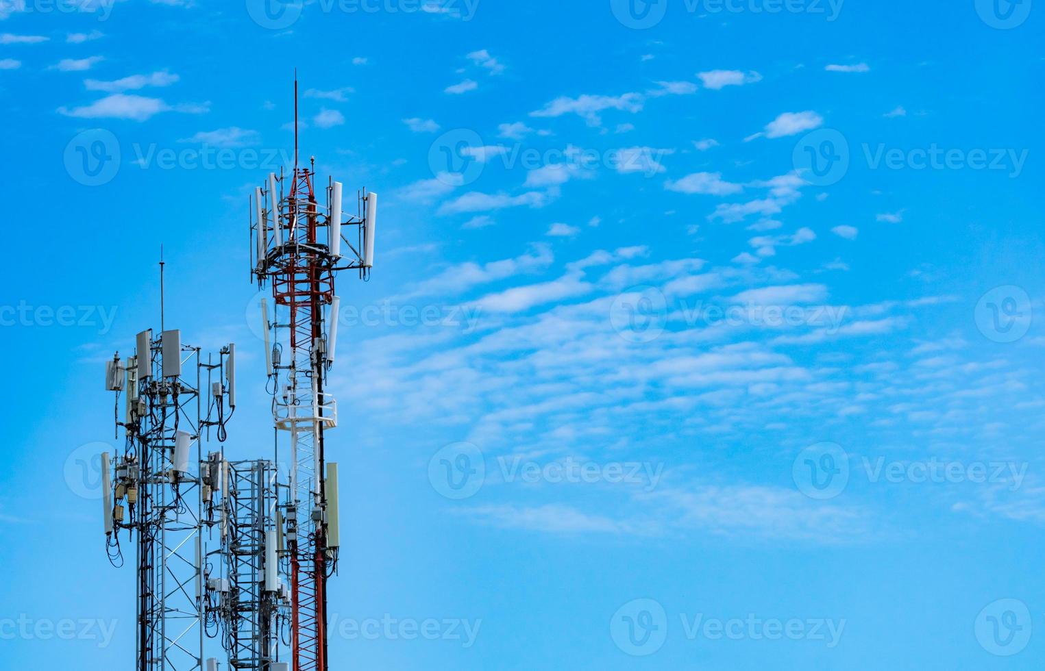 Telecommunication tower with blue sky and white clouds background. Antenna on blue sky. Radio and satellite pole. Communication technology. Telecommunication industry. Mobile or telecom 4g network. photo