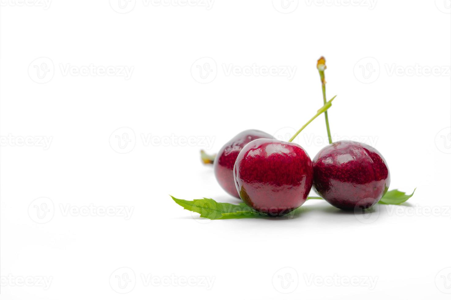 Red cherry with stalk and leaf isolated on white background. Ripe red sweet cherry. Sweet and juicy organic cherry. Fresh fruit for summer dessert. Raw material for jam industry. Antioxidant food. photo