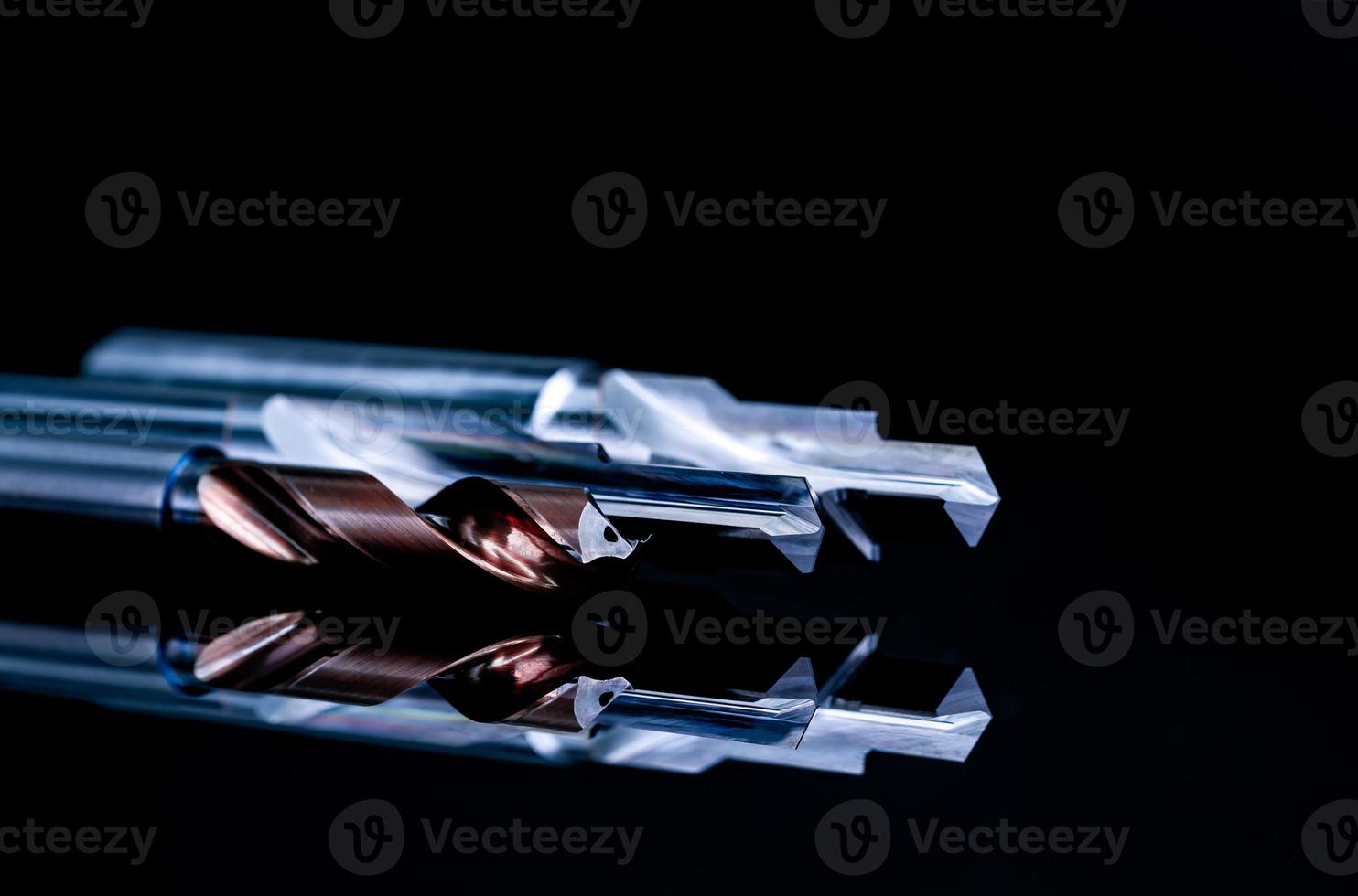 Special tools isolated on black background. Made to order special tools. Coated step drill and reamer detail. HSS cemented carbide. Carbide cutting tool for industrial applications. Engineering tools. photo