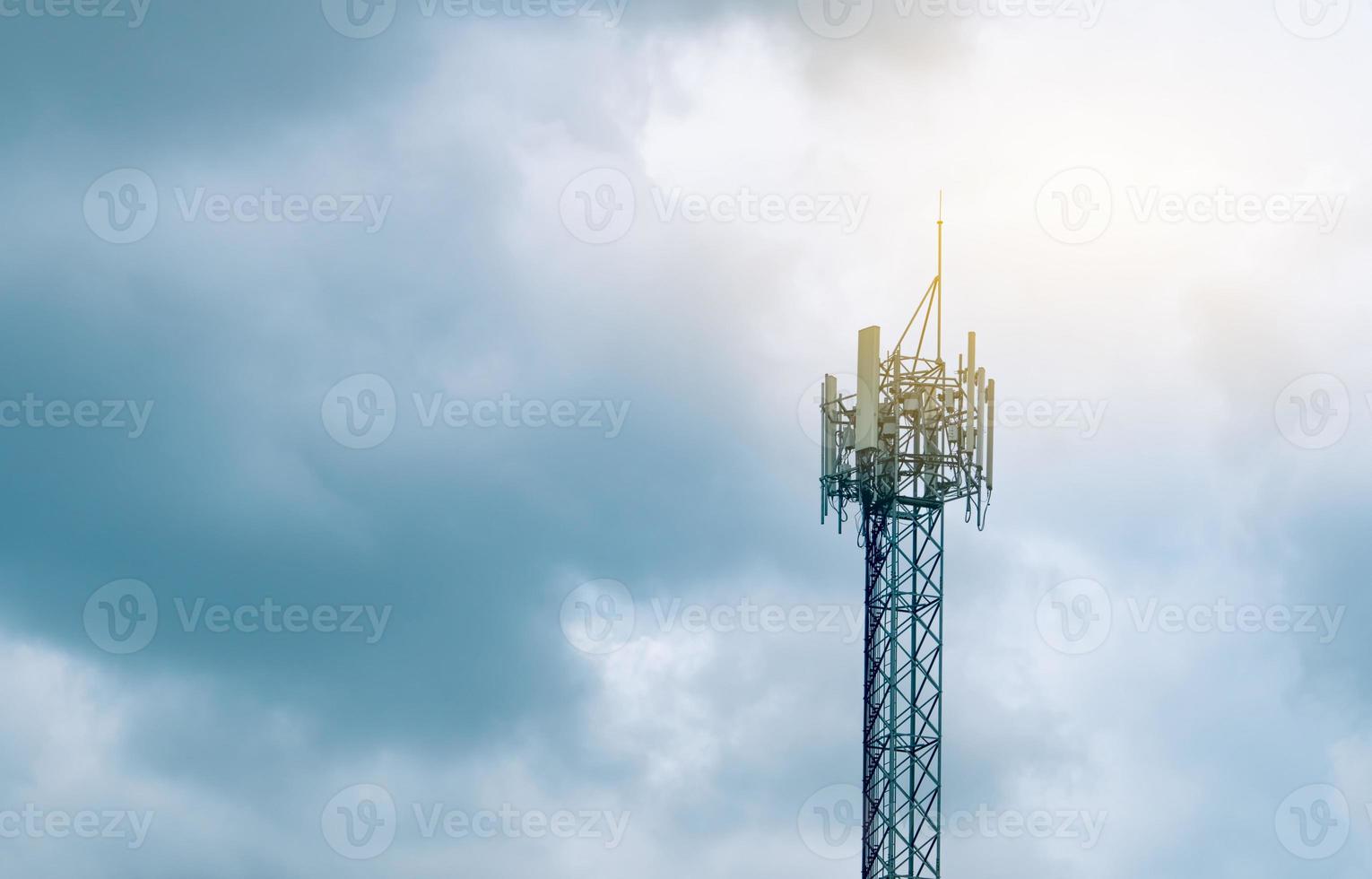 Telecommunication tower with cloudy sky background. Antenna on blue sky. Radio and satellite pole. Communication technology. Telecommunication industry. Mobile or telecom 5g network. Technology photo