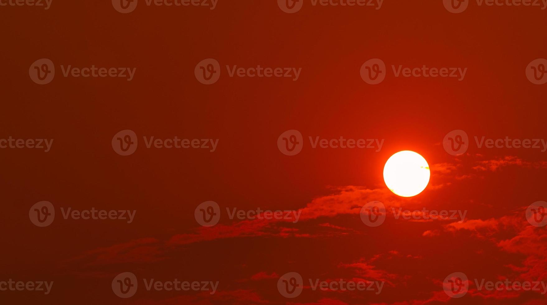 Round big sun and red sunset sky in the evening with space for inspiration quote. Beauty in nature. Beautiful summer sunset sky. Tranquil and peaceful background. Heat temperature. Vermilion sky. photo