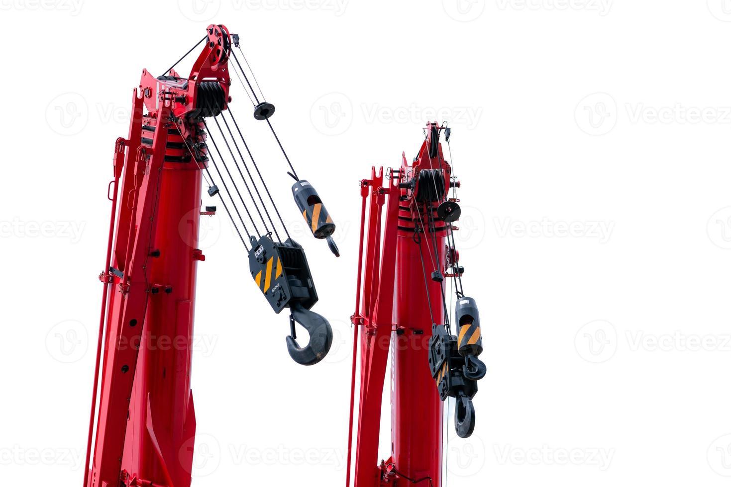 Construction crane for heavy lifting isolated on white background. Construction industry. Red crane with hook for lifting 60T and 30T load. Crane for rent. Crane dealership for construction business. photo