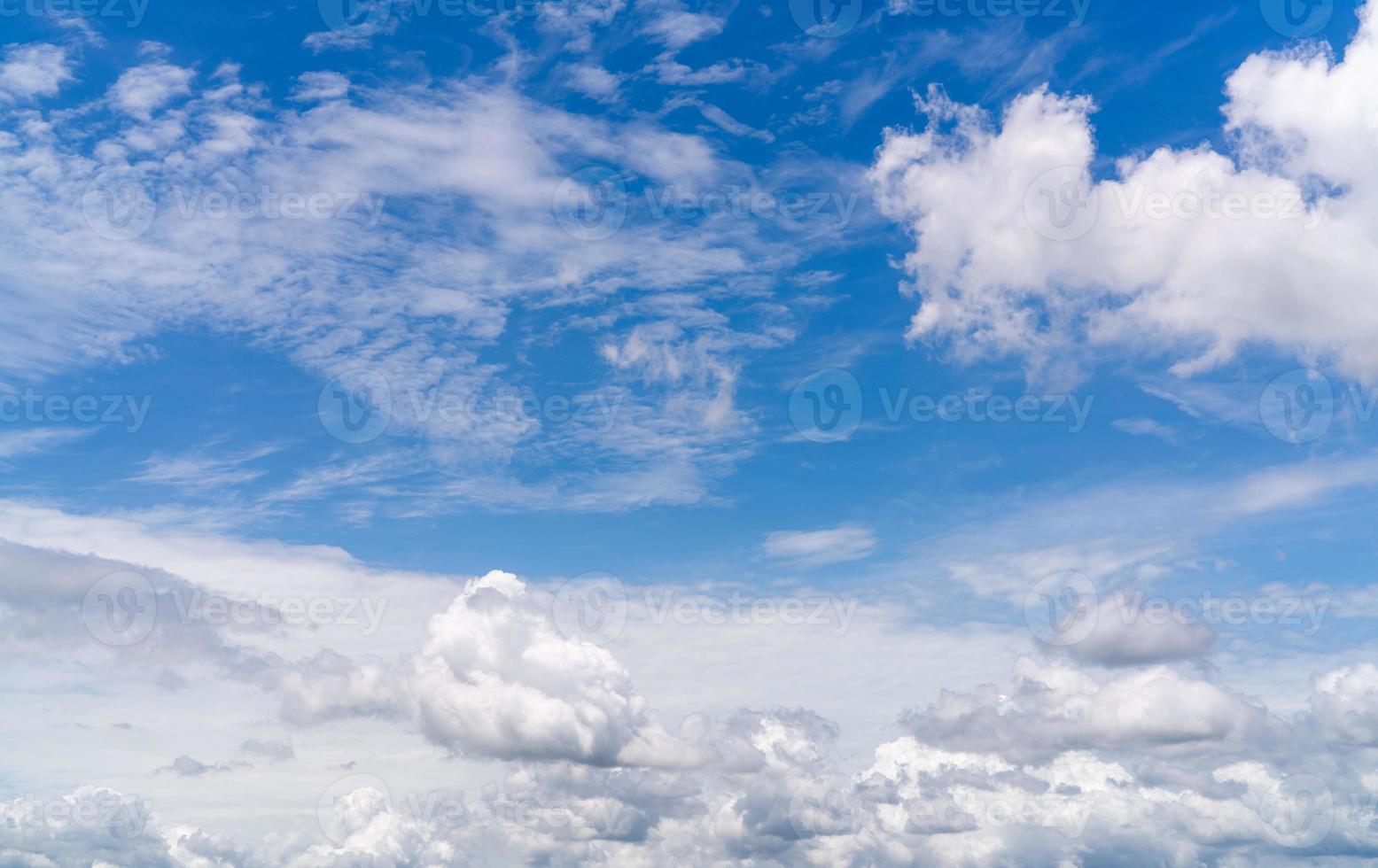 White fluffy clouds on blue sky. Soft touch feeling like cotton. White puffy clouds cape with space for text. Beauty in nature. Close-up white cumulus clouds texture background. Sky on sunny day. photo