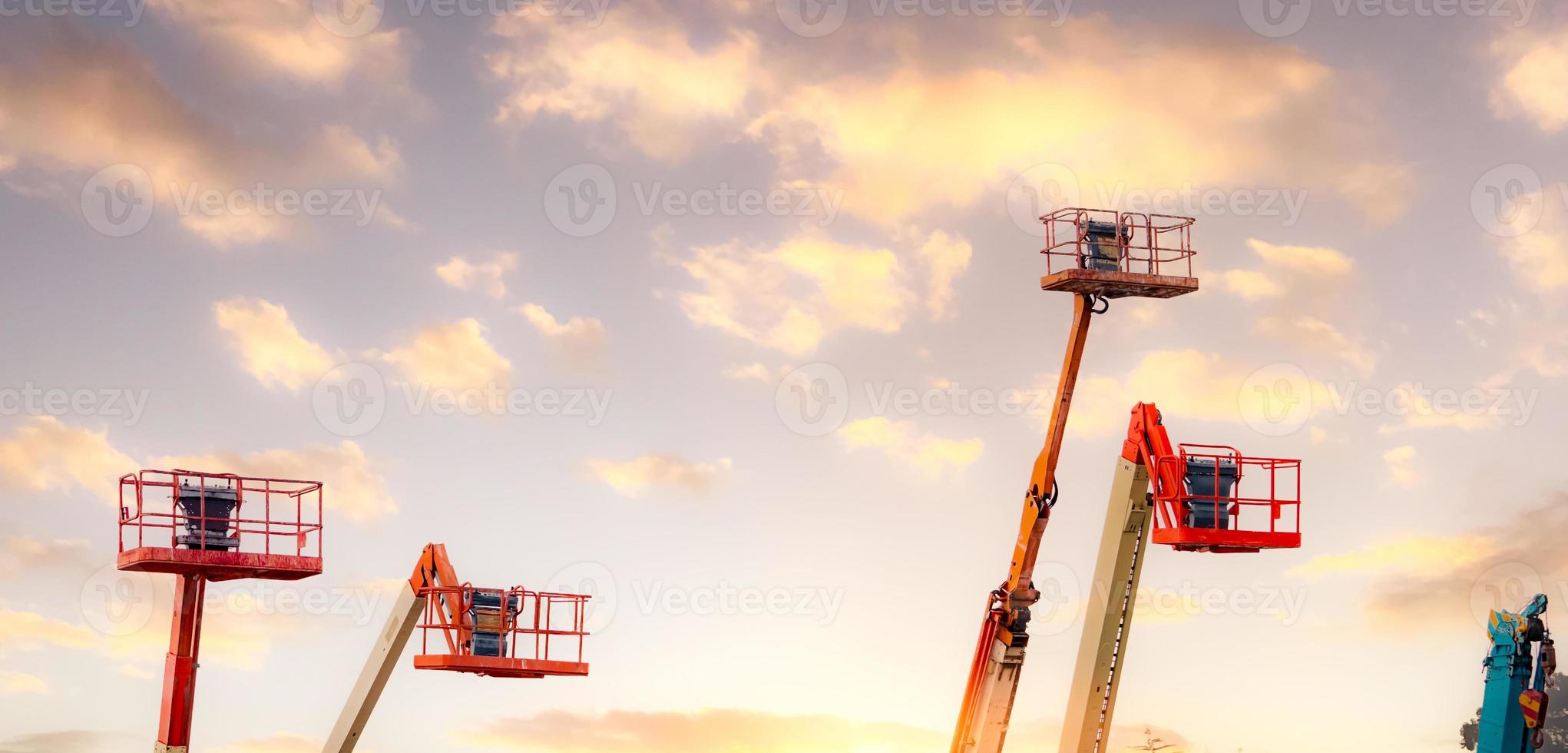 Articulated boom lift. Aerial platform lift. Telescopic boom lift against the sky. Mobile construction crane for rent and sale. Maintenance and repair hydraulic boom lift service. Crane dealership. photo