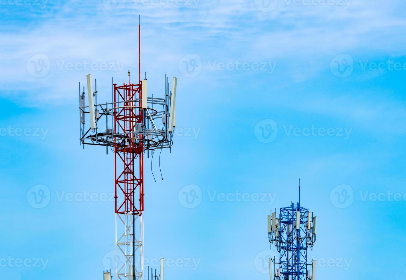 Telecommunication tower with blue sky and white clouds background. Antenna on blue sky. Radio and satellite pole. Communication technology. Telecommunication industry. Mobile or telecom 4g network. photo