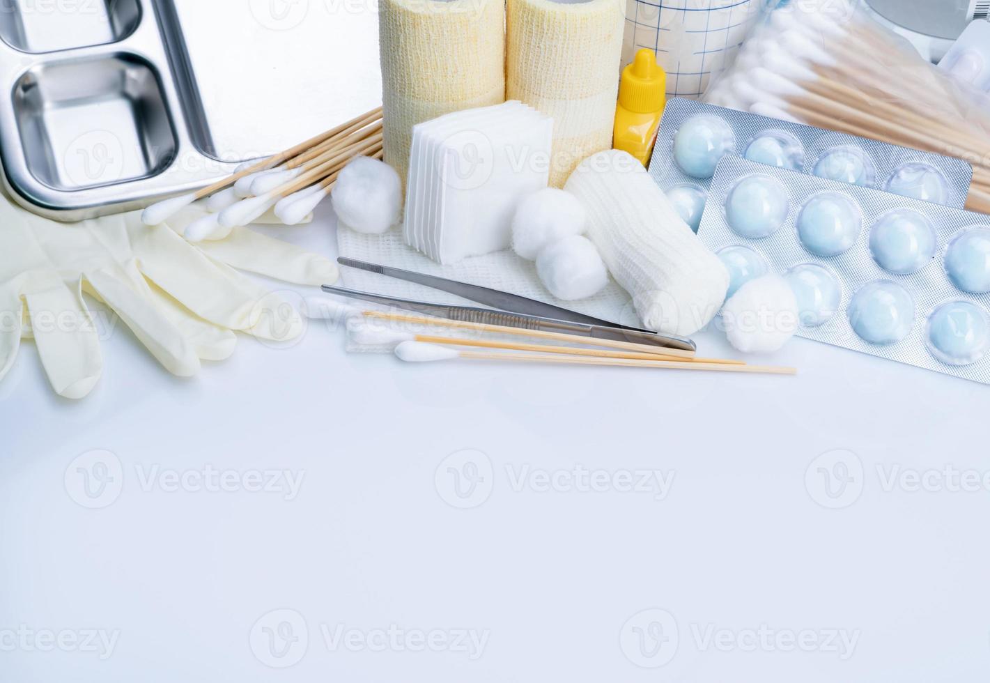 Wound care dressing set. Medical supply for diabetes, surgical and accidental wounds care. Medical equipment for nurse. Forceps, cotton stick, conform bandage, povidone-iodine bottle and latex gloves. photo