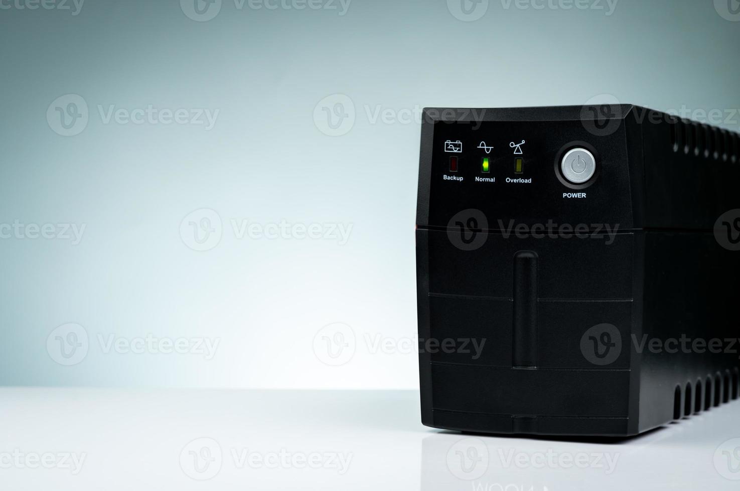 Uninterruptible power supply. Backup Power UPS with battery isolated on table. UPS for PC. Equipment for computer system at office for security. Power protection solutions from home to data center. photo