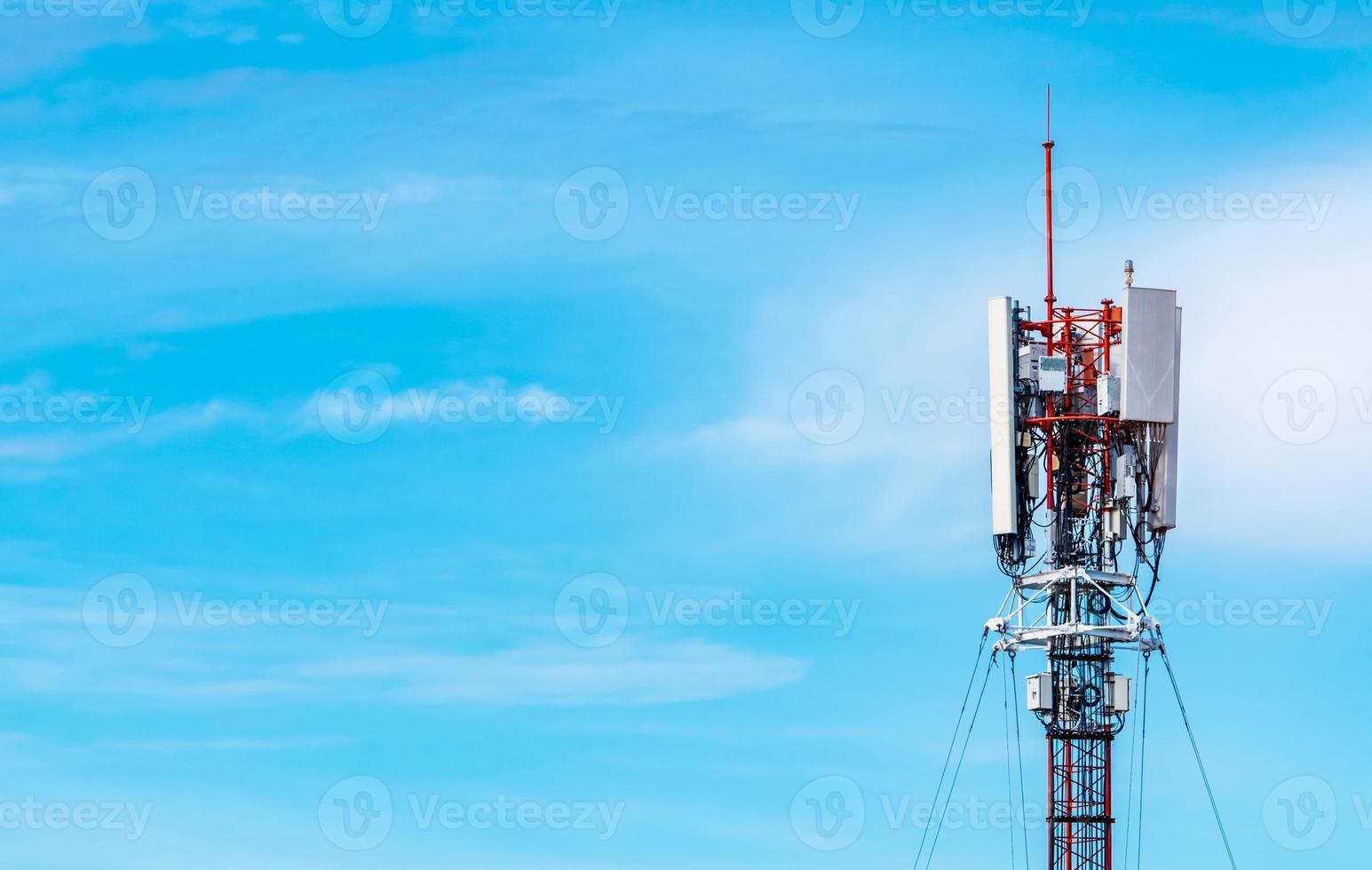Telecommunication tower with blue sky and white clouds background. Antenna on blue sky. Radio and satellite pole. Communication technology. Telecommunication industry. Mobile or telecom 4g network. photo