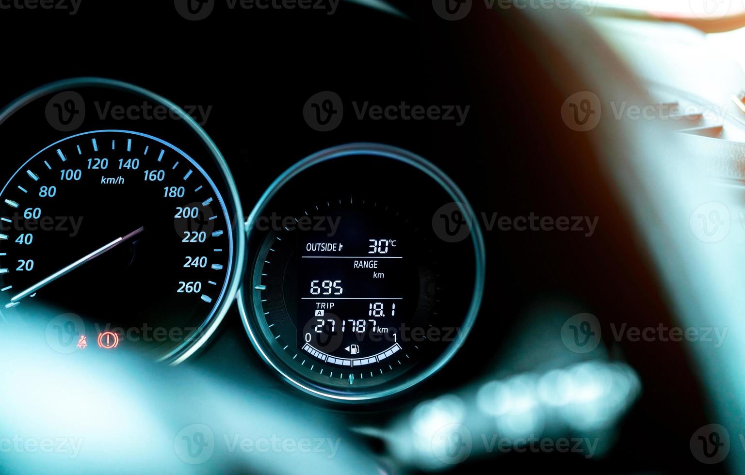 Closeup car fuel gauge dashboard panel. Gasoline indicator meter and speedometer. Fuel gauge show full gas tank. Data information dashboard show outside car temperature, trip range and fuel tank icon. photo