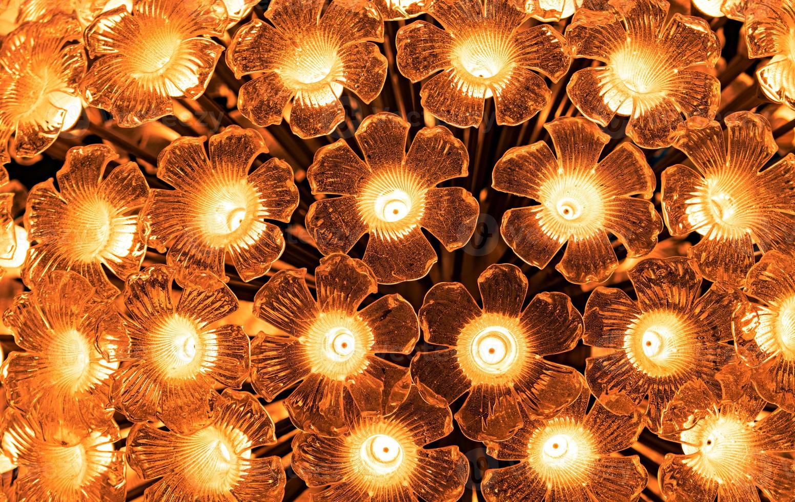 Flower shaped glass lamp. LED light bulb decorative with flower shaped glass. Decorative light in classic design style. Golden light for interior building decor in festival or event. Lighting. photo
