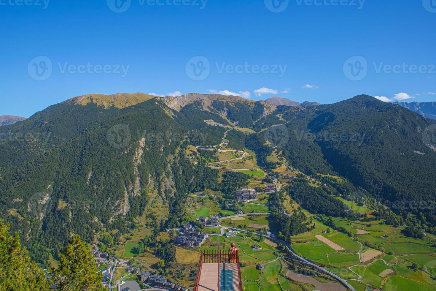 Aerial View of Canillo town and nature mountains landscape from Roc del Quer observation deck during a sunny spring day in Andorra photo