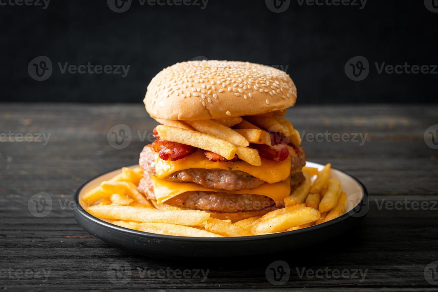 pork burger with cheese, bacon and french fries photo