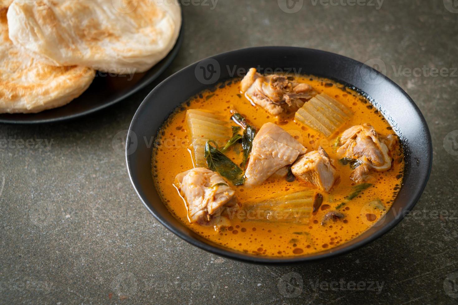 Chicken curry soup with roti photo