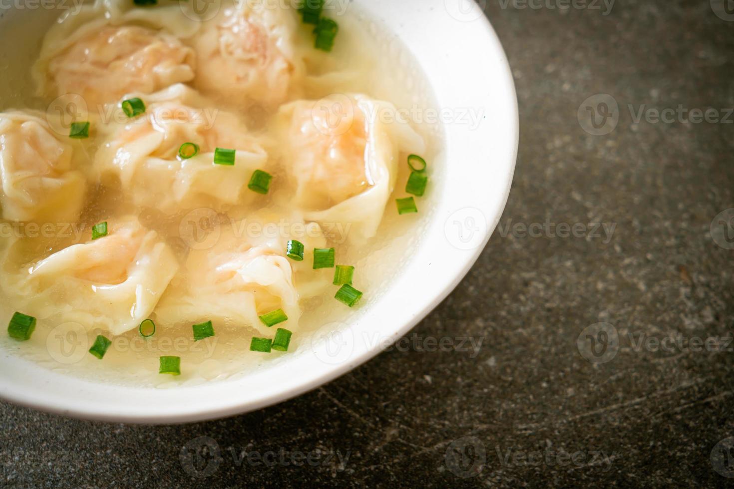 shrimp dumpling soup in white bowl photo