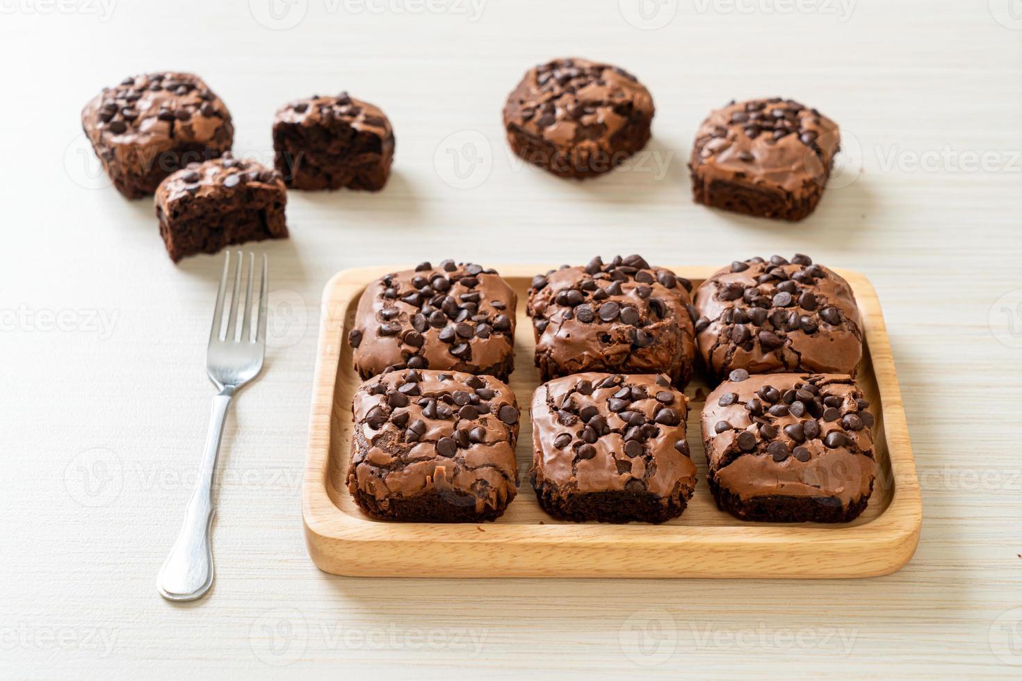 dark chocolate brownies topped by chocolate chips photo