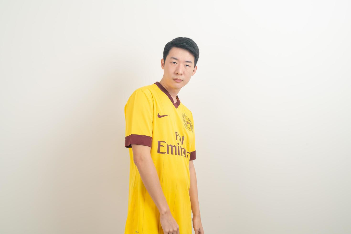 Bangkok, THAILAND - Nov 27, 2021 - Young Asian man wearing Arsenal shirt with white background. photo