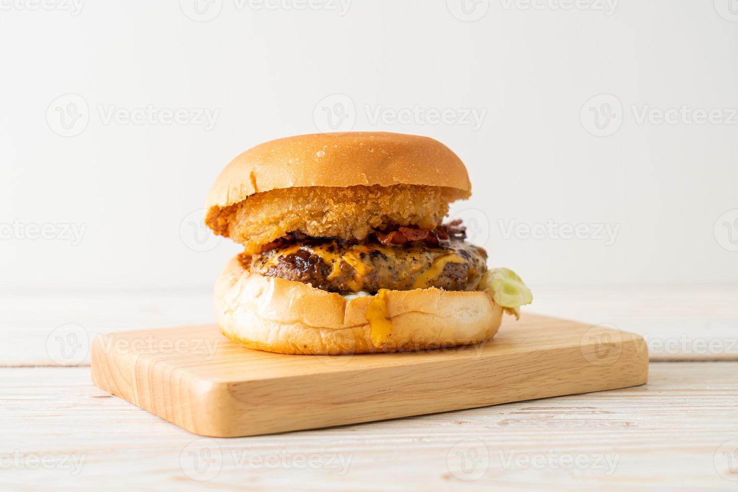 beef burger with cheese, bacon and onion rings photo