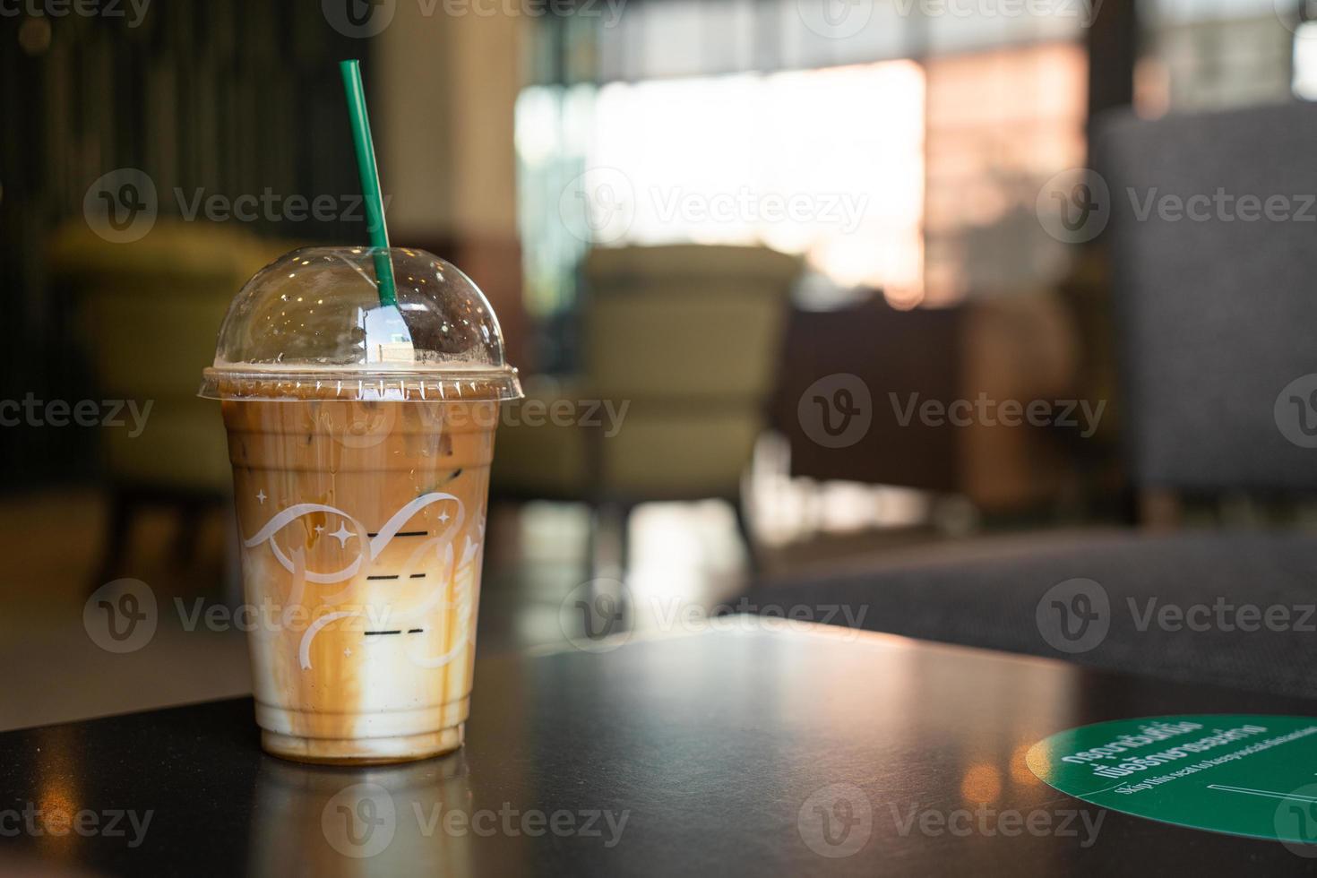 caramel macchiato coffee cup in coffee shop photo