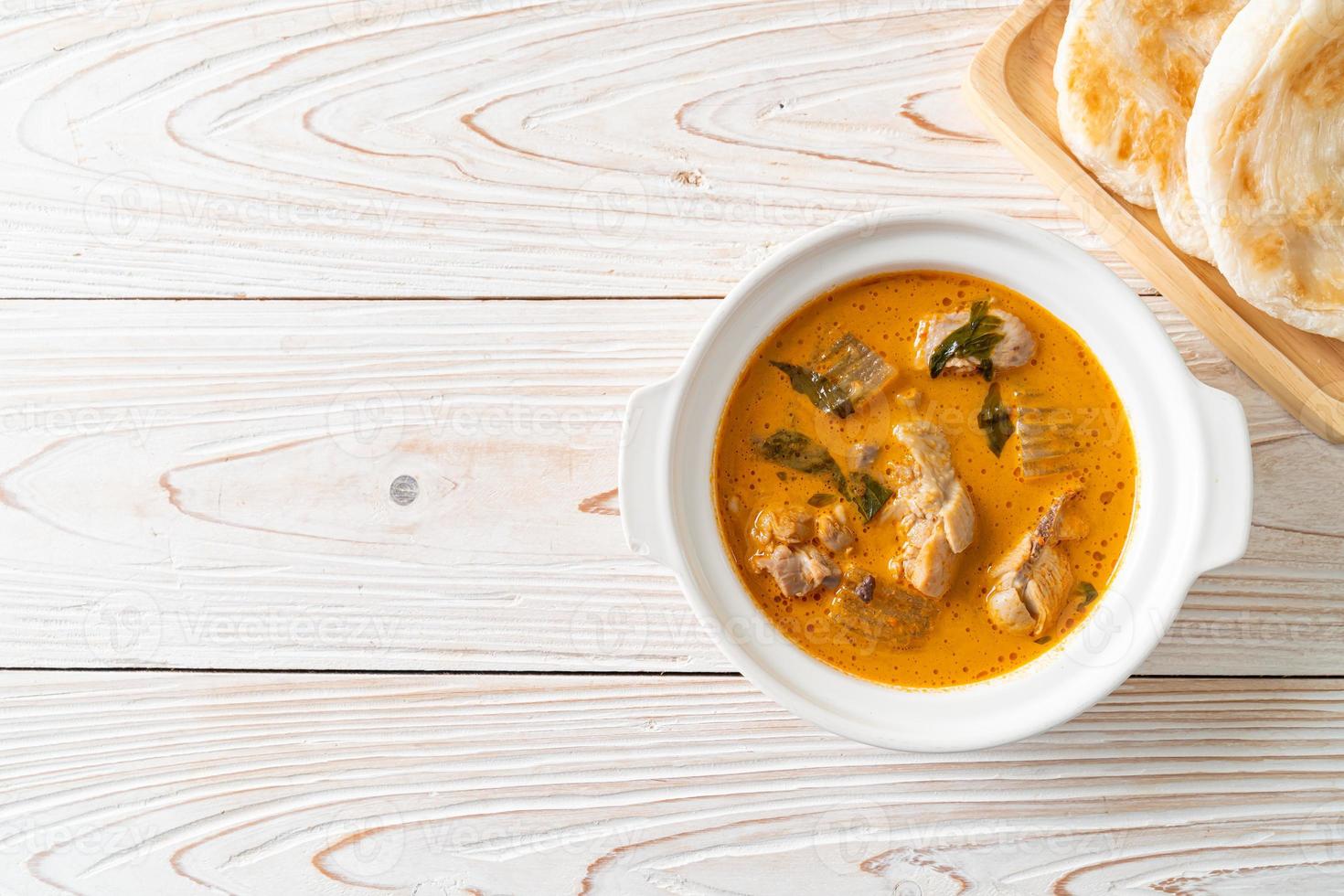 Chicken curry soup with roti photo