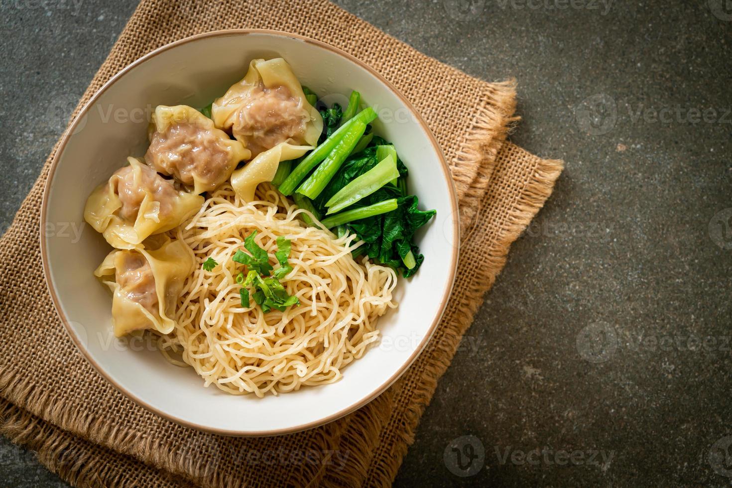 dried egg noodles with pork wonton or pork dumplings without soup photo
