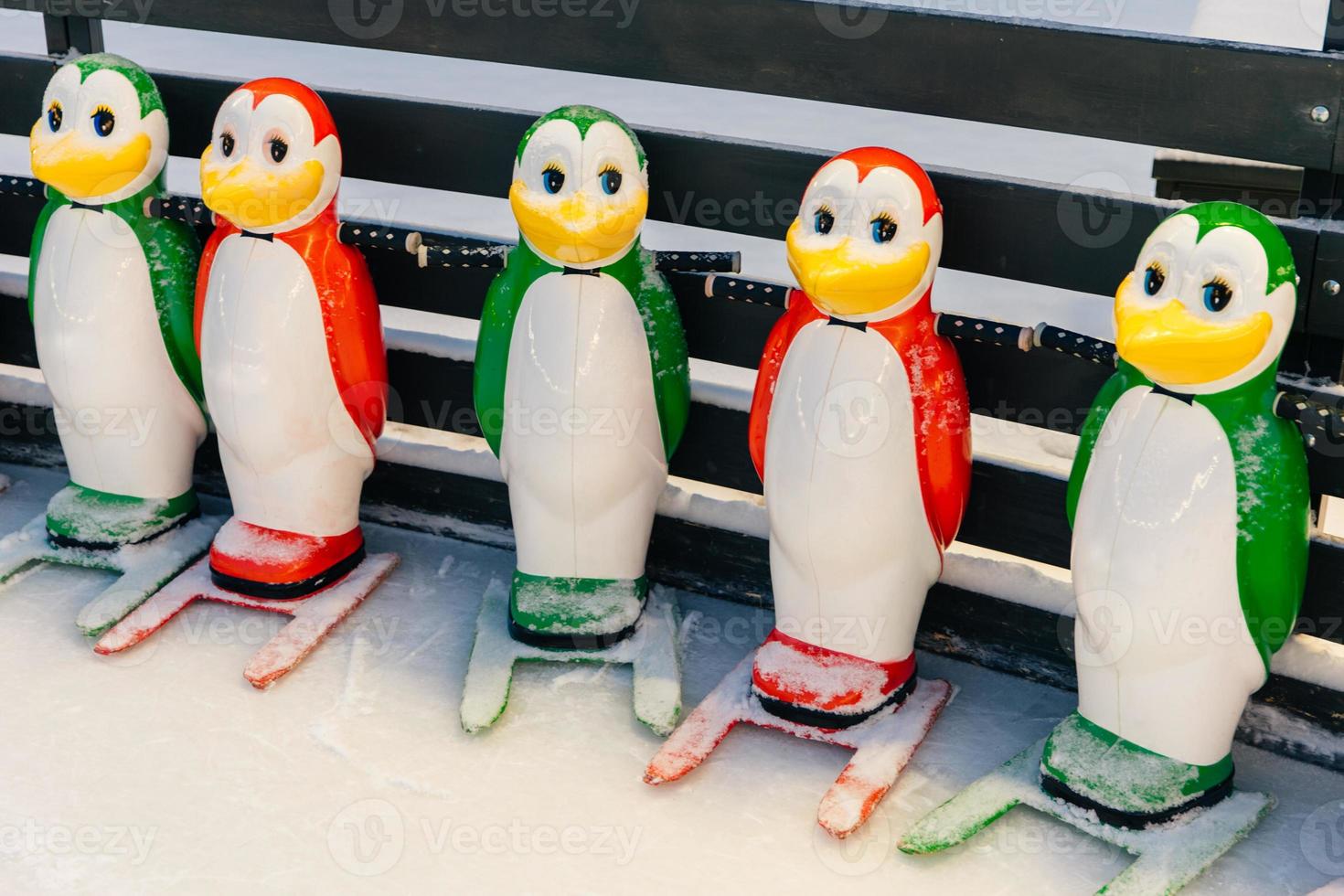 Shot of special equipment needed for skating, helping people to keep balance on ice rink. Helpers for skater beginners. Colourful figures in form of penguins photo