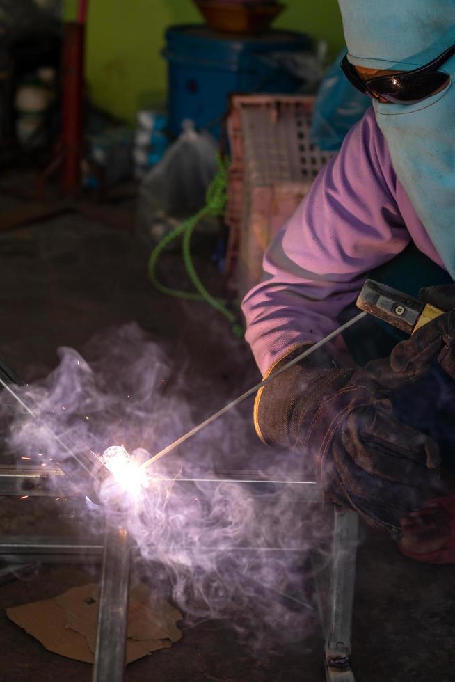 Welding of steel and fabric covering the face. photo