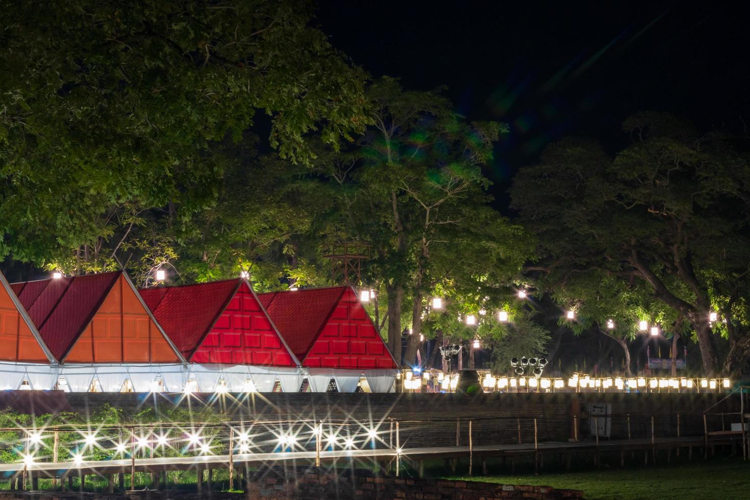 Bungalow with walkway and lights and trees. photo