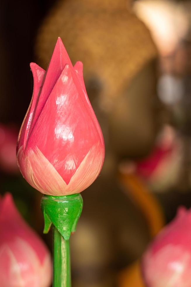 Pink lotus flowers made of wood and Buddha. photo