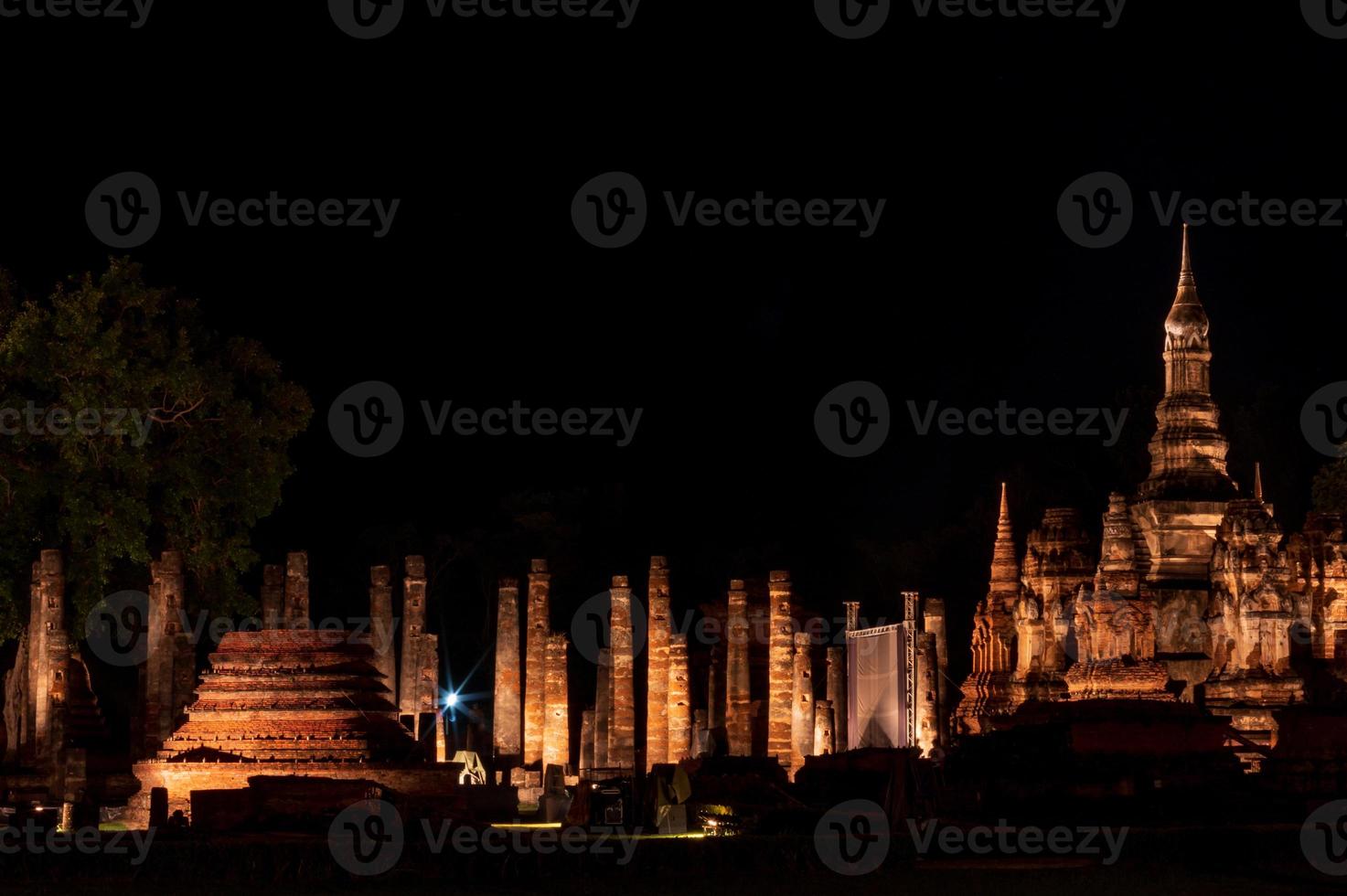 Old Buddhist temple with light in the dark. photo